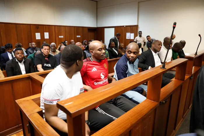 The seven men accused of killing rapper Kiernan 'AKA' Forbes and chef Tebello 'Tibz' Motsoane in the dock at Durban High Court. From left Lindokuhle Thabani Mkhwanazi, Lindani Zenzele Ndimande, Siyanda Eddie Myeza, Mziwethemba Harvey Gwabeni, Lindokuhle Lindo Ndimande and brothers Siyabonga Gezani Ndimande and Malusi Dave Ndimande